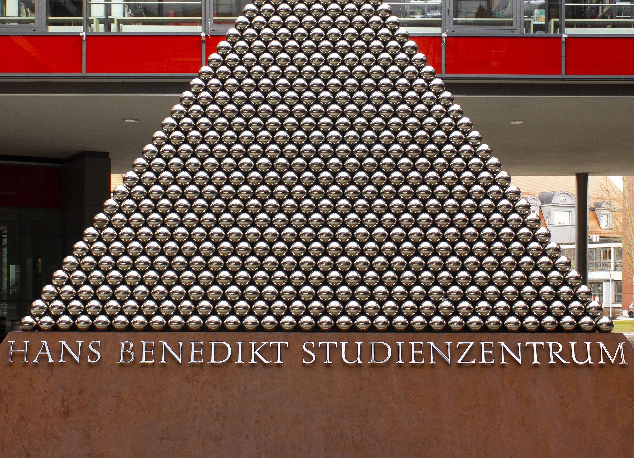 Art piece (pyramid shape) on the campus of Hochschule Augsburg featuring custom stainless steel lettering by Hans R. Heitmann